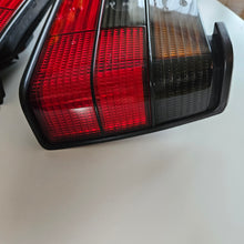 Load image into Gallery viewer, Hella Smoked Tail Light Set Jetta Mk2
